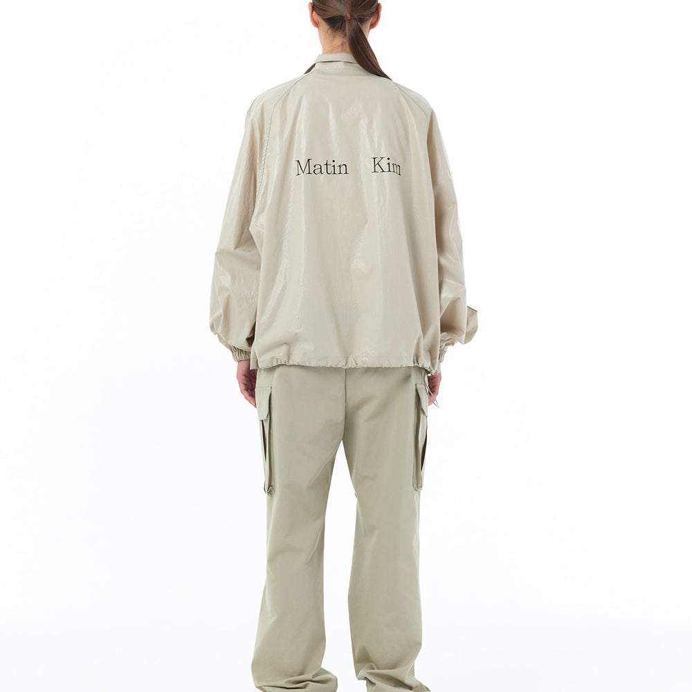 
                  
                    MATIN KIM LOGO COATING JUMPER IN BEIGE
                  
                