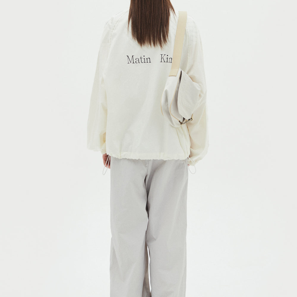 
                  
                    MATIN KIM LOGO COATING JUMPER IN IVORY
                  
                