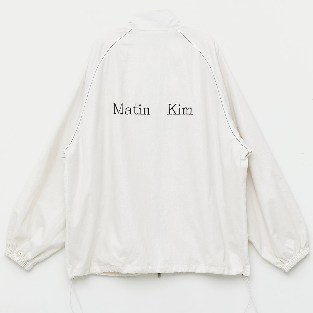 
                  
                    MATIN KIM LOGO COATING JUMPER IN IVORY
                  
                